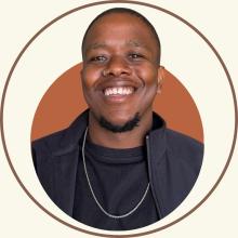 Kgotla Mmopi person wearing black jacket and necklace against orange background